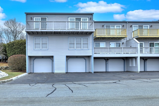 rear view of house featuring an attached garage