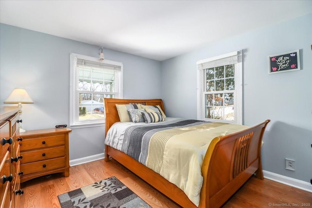 bedroom with wood finished floors and baseboards