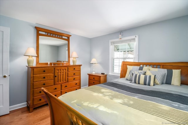 bedroom featuring light wood-type flooring and baseboards