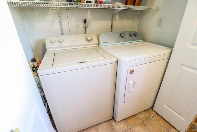 laundry room featuring laundry area, light tile patterned floors, and independent washer and dryer