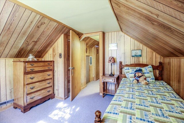 carpeted bedroom with visible vents, lofted ceiling, wood ceiling, and wood walls