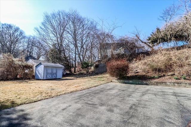 view of yard with an outbuilding and a storage shed