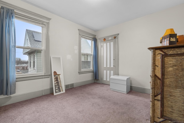 unfurnished bedroom featuring carpet floors, visible vents, and baseboards