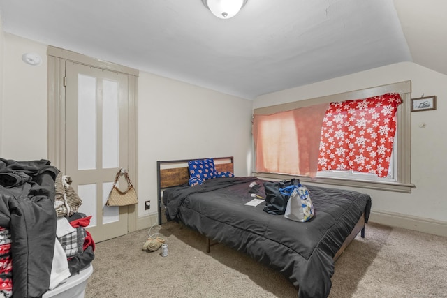 bedroom featuring carpet, vaulted ceiling, and baseboards