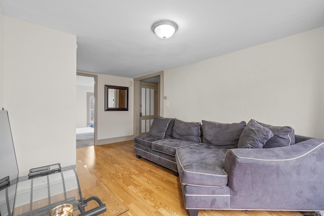 living room with light wood-type flooring and baseboards