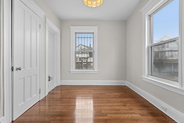 interior space featuring wood finished floors and baseboards