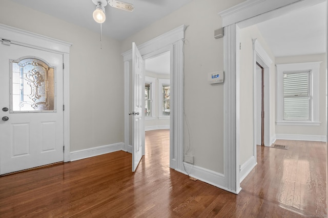 entrance foyer with a wealth of natural light, baseboards, and wood finished floors