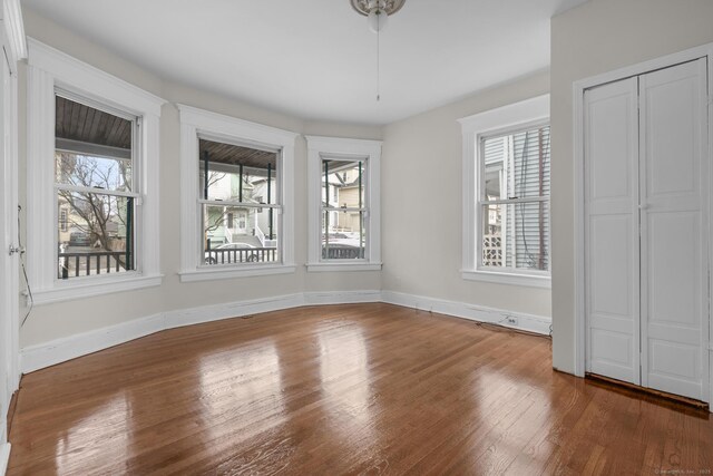 interior space featuring wood finished floors and baseboards