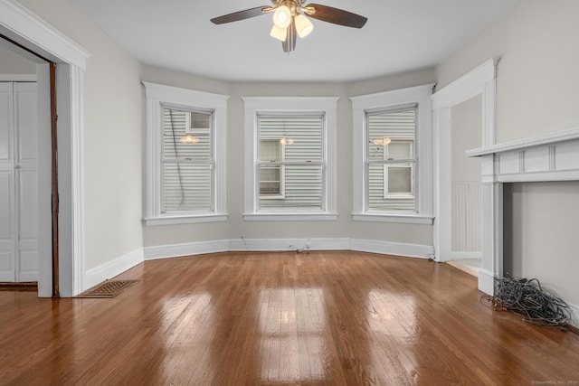 unfurnished dining area featuring a ceiling fan, wood-type flooring, visible vents, and baseboards