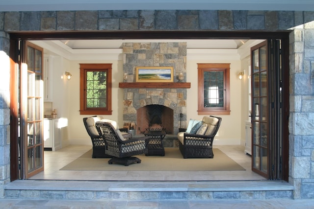 living area with a fireplace and baseboards