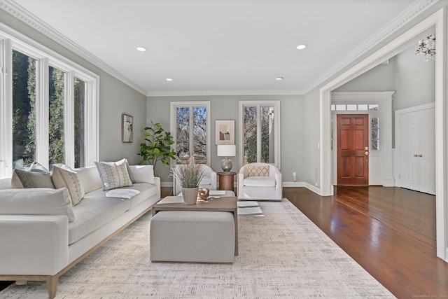 living area featuring recessed lighting, baseboards, wood finished floors, and crown molding