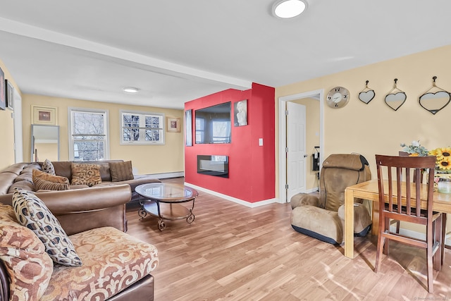 living area with baseboards and light wood-style flooring