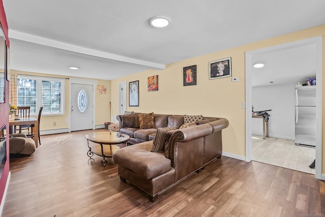 living area with beamed ceiling, wood finished floors, baseboards, and a baseboard radiator