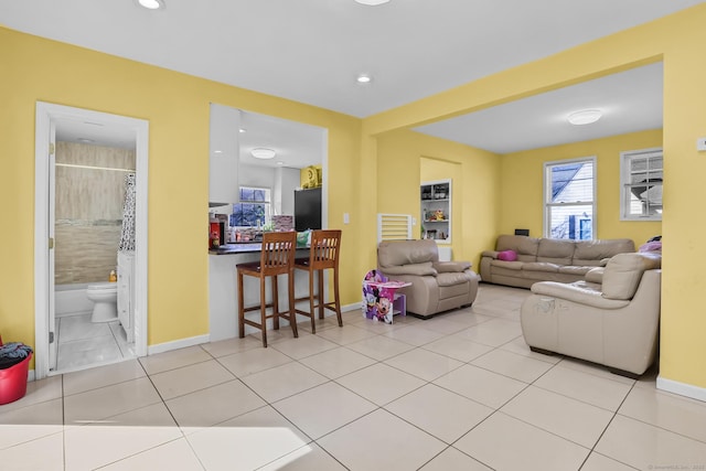 living room featuring tile patterned flooring, recessed lighting, and baseboards