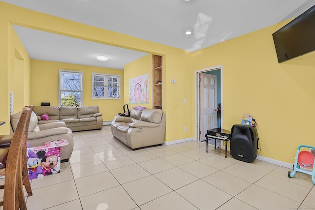 living room with light tile patterned floors, baseboards, and built in shelves