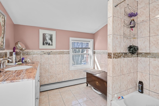 bathroom featuring vanity, a bathing tub, tile patterned flooring, tile walls, and baseboard heating