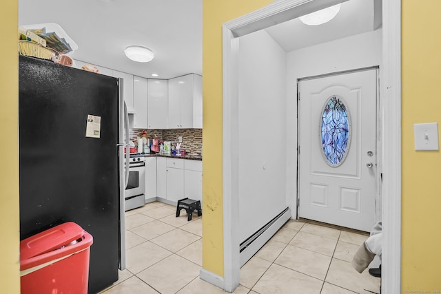 entryway with light tile patterned flooring and a baseboard heating unit