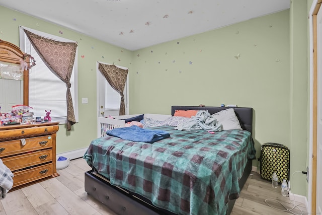 bedroom featuring baseboards and light wood-style floors