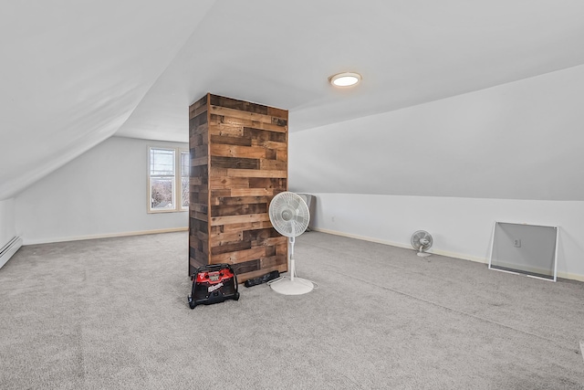 additional living space featuring vaulted ceiling, baseboards, and carpet floors