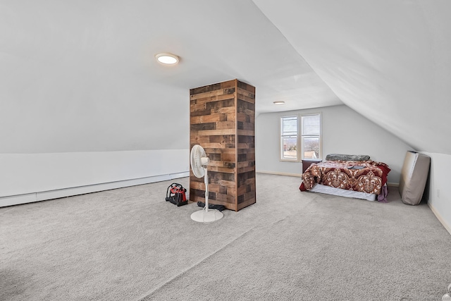 bedroom with carpet flooring, baseboards, a baseboard heating unit, and lofted ceiling