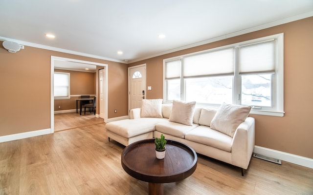 living room with recessed lighting, visible vents, ornamental molding, light wood-type flooring, and baseboards