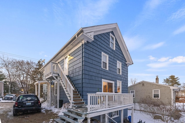 exterior space featuring a wooden deck and stairs