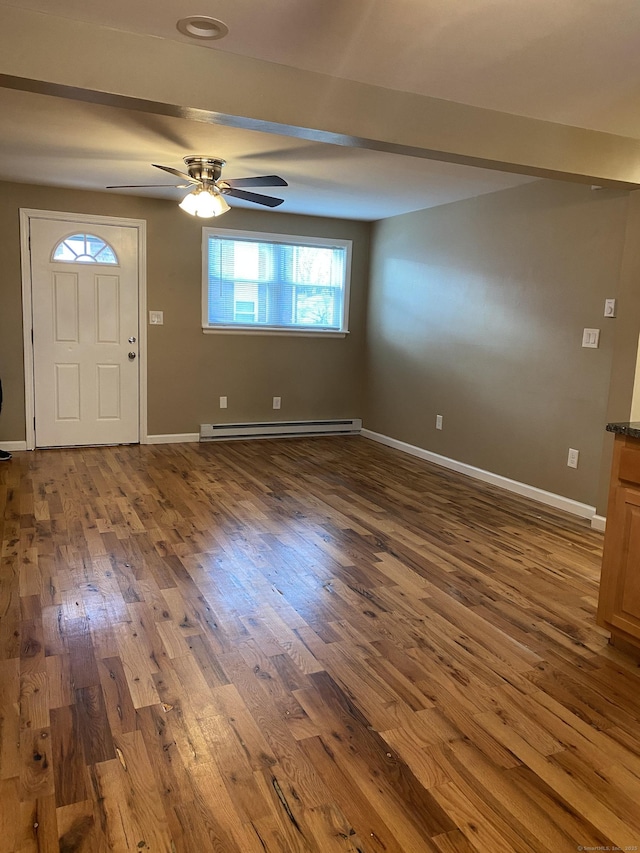 entryway with a baseboard heating unit, baseboards, beamed ceiling, and hardwood / wood-style flooring