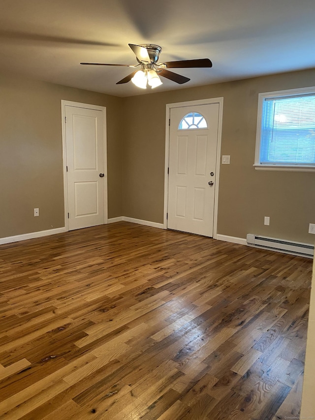 entryway with wood finished floors, baseboards, and baseboard heating