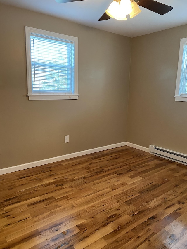 empty room featuring baseboards, wood finished floors, and a ceiling fan