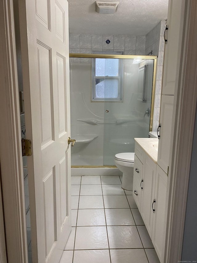 full bath featuring tile patterned floors, visible vents, a textured ceiling, and a stall shower