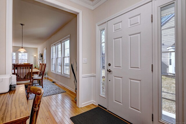 entryway featuring baseboards and light wood finished floors