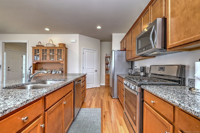 kitchen with a sink, brown cabinets, and appliances with stainless steel finishes