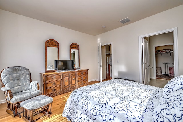 bedroom featuring visible vents and wood finished floors