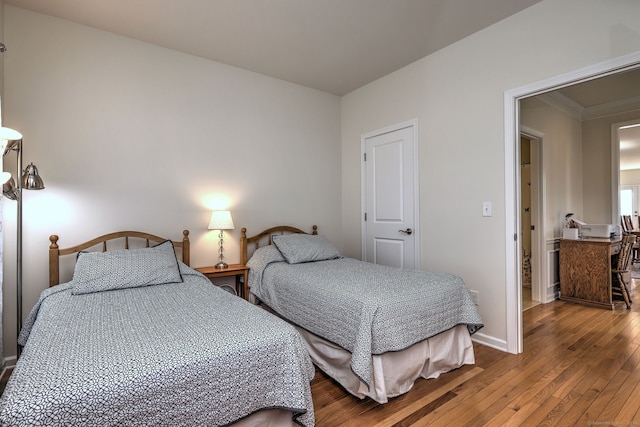 bedroom featuring hardwood / wood-style floors and baseboards