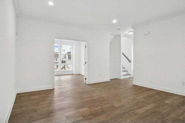 empty room with recessed lighting, stairway, ornamental molding, wood finished floors, and baseboards