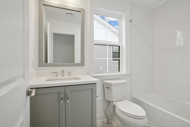 full bath featuring baseboards, visible vents, toilet, bathtub / shower combination, and vanity