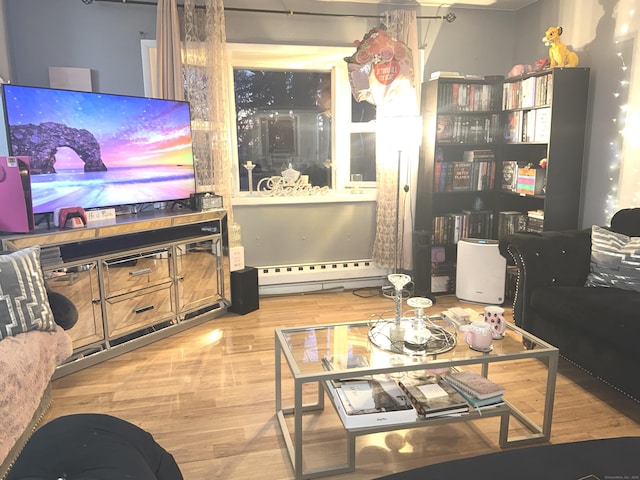 living area featuring baseboard heating and wood finished floors