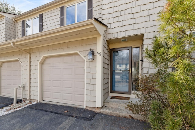 doorway to property featuring an attached garage