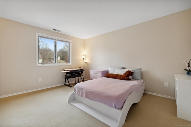 bedroom with light carpet, visible vents, and baseboards