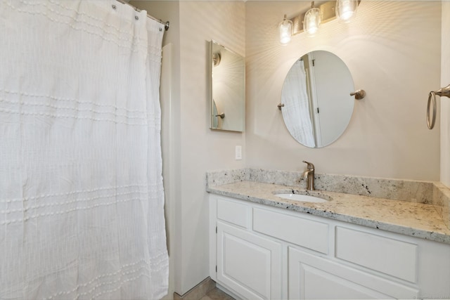 full bathroom with curtained shower and vanity