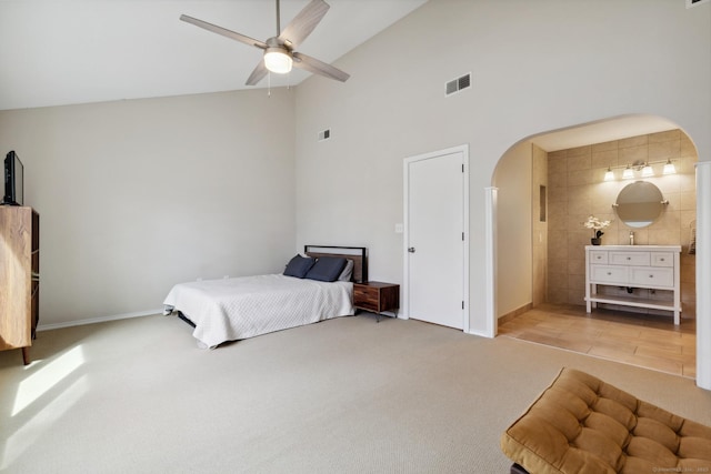 bedroom featuring carpet flooring, arched walkways, visible vents, and ceiling fan