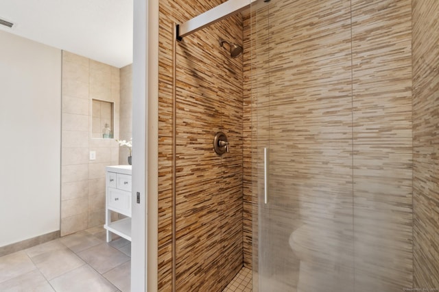 bathroom with vanity, a shower stall, visible vents, and tile patterned floors