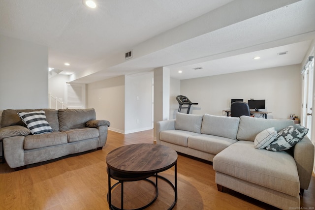 living area featuring light wood finished floors, visible vents, recessed lighting, and baseboards