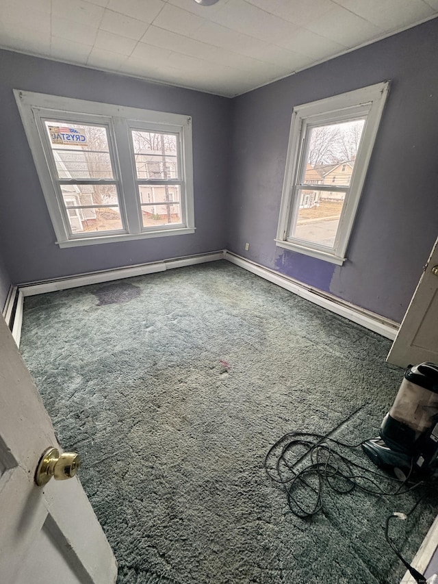 carpeted empty room featuring baseboards