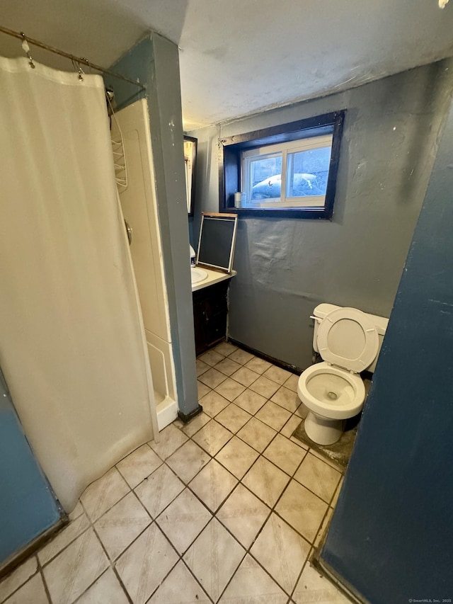 full bathroom with toilet, a stall shower, vanity, and tile patterned flooring