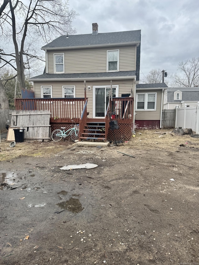 back of house with a wooden deck and fence