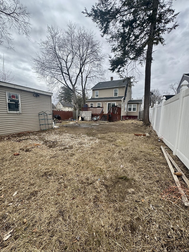 view of yard featuring a fenced backyard and a deck