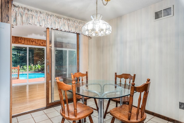 dining room featuring a notable chandelier, visible vents, and light tile patterned floors