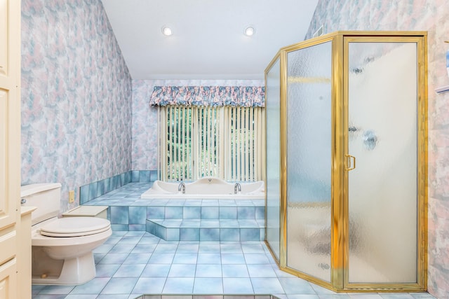 bathroom featuring a stall shower, toilet, a bath, and wallpapered walls