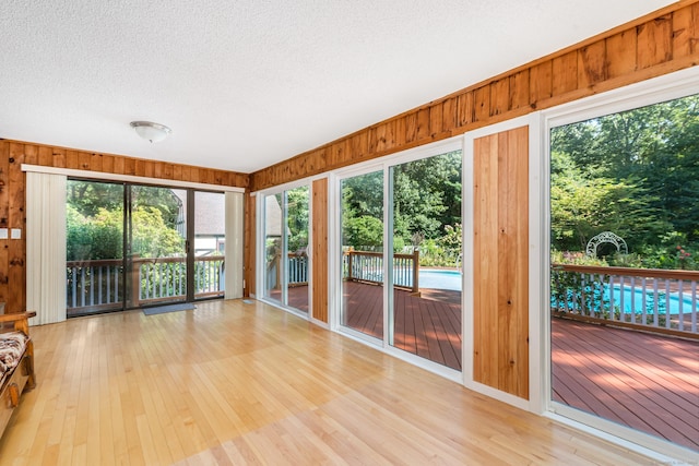 unfurnished sunroom featuring a healthy amount of sunlight
